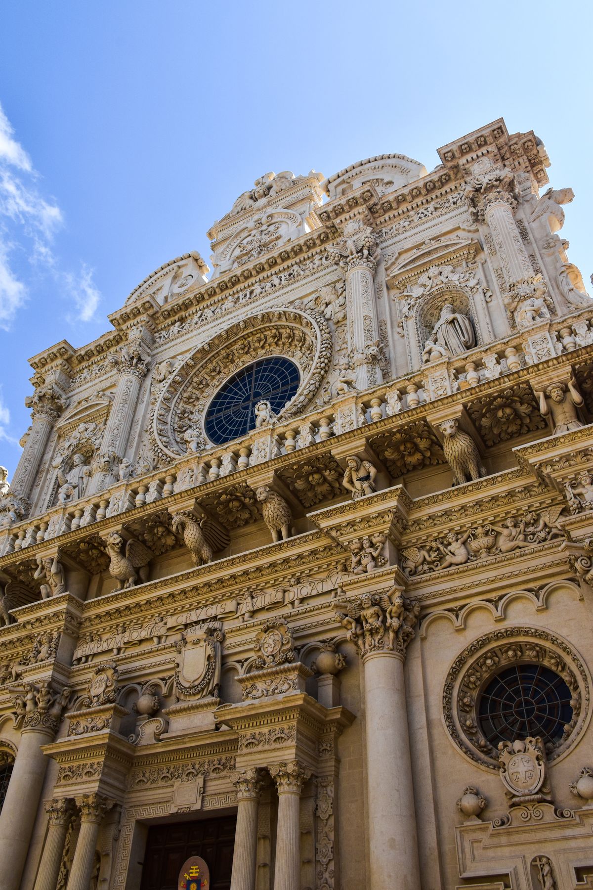 Ornate Baroque church facade in Lecce against a blue sky